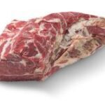 A piece of meat is sitting on the table.