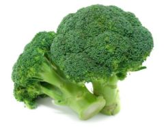 Two pieces of broccoli are sitting on a table.