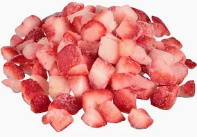 A pile of chopped strawberries on top of each other.