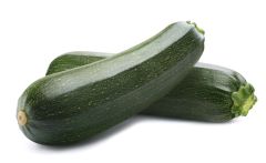 Two zucchini halves are sitting next to each other.