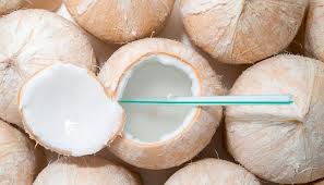 A close up of some coconuts with one coconut cut in half