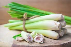 A bunch of green onions on top of a wooden board.